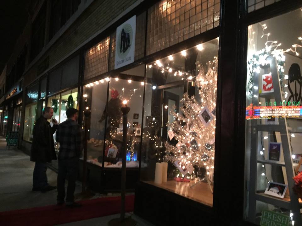 A store front with people walking by it