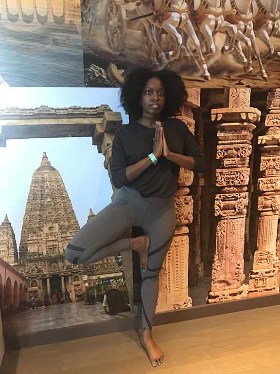 D_LLOYD-1 Woman practicing yoga in front of temple.