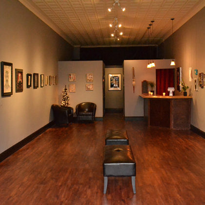 Art gallery interior with framed artworks displayed.
