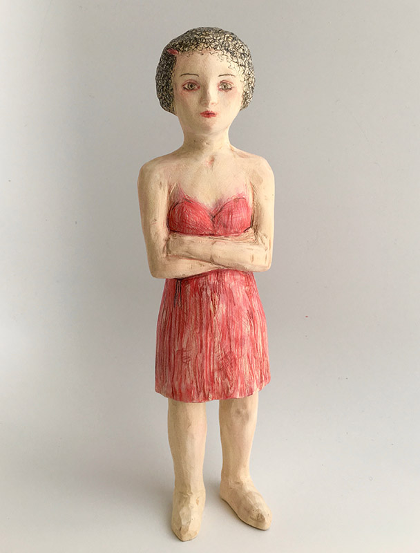 BARBARA_HART_TAKING_STOCK Clay figure wearing a red dress.