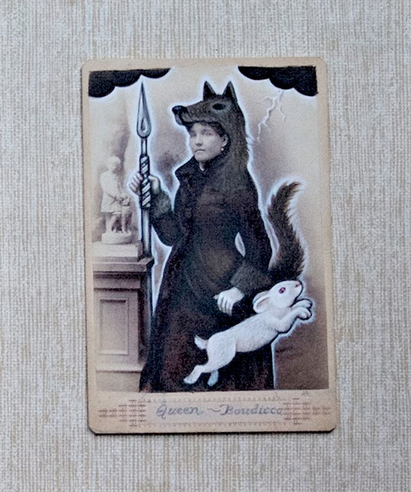 KELLY_VETTER_B Person in wolf costume holding spear, rabbit.