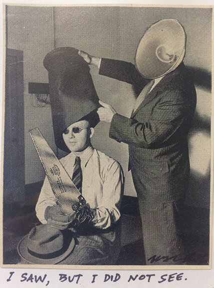 winston_smith_I_saw_but_I_did_not_see Two men with surreal headgear and chainsaw.