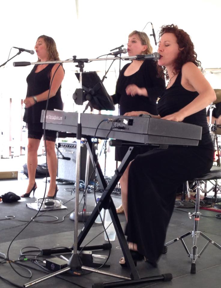 annie_theresa_trio-1 Three women performing music on stage.