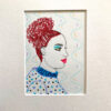 A drawing of a woman with red hair.