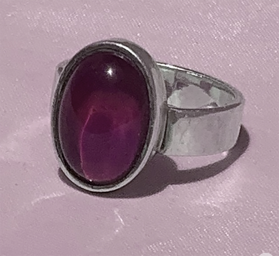 DAY23_MOOD_RING-1 Silver ring with oval purple gemstone.