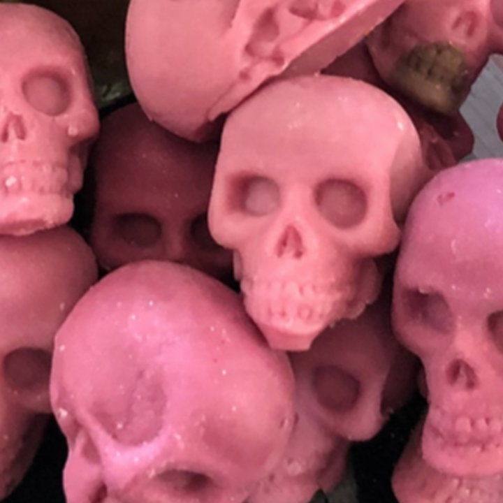 DAY26_SKULL_WAX_MELTS-1 Pink skull-shaped objects stacked together.