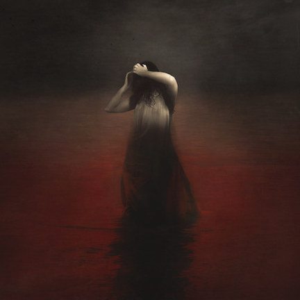 Jen_Kiaba_Wanderer A woman in white dress standing on red floor.