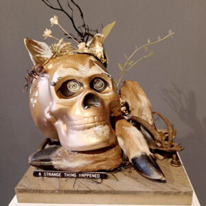A gold skull with flowers on it's head.