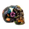 A black skull with flowers and birds on it.