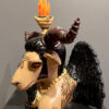 A ceramic sculpture of an animal with horns and a candle on top.