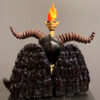 A sculpture of an evil looking demon with horns.