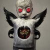 A creepy doll with wings and red eyes.